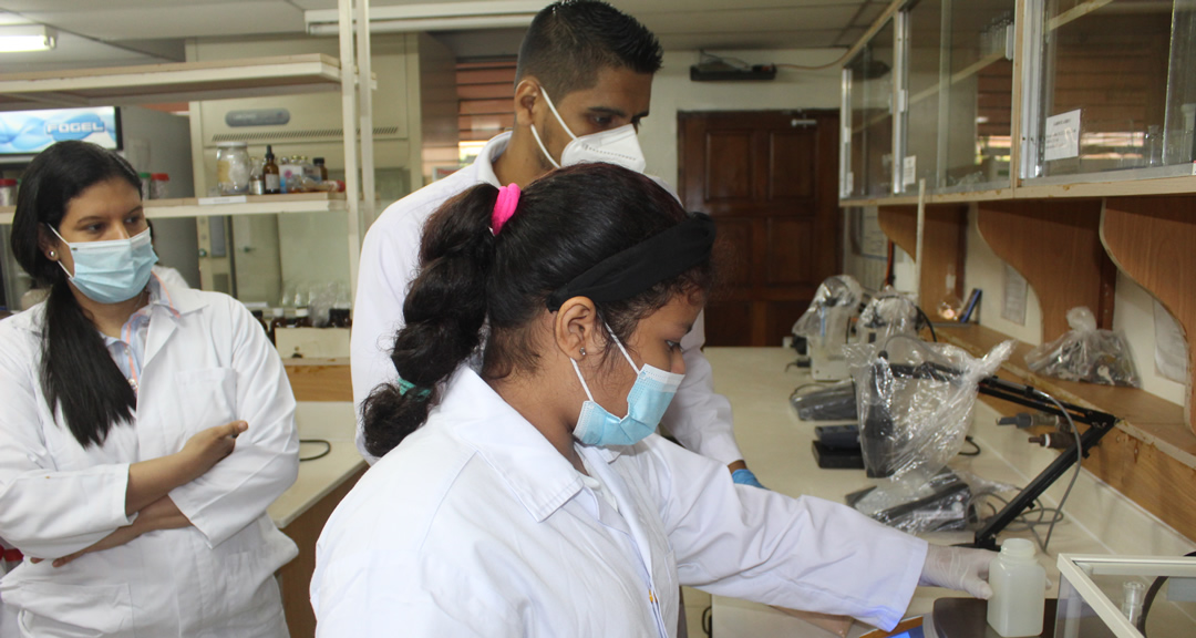 Estudiantes realizan práctica de medición de pH.